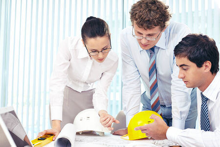 Three architects discussing sketch of new project