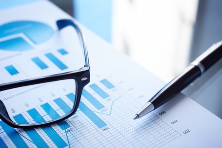 Image of eyeglasses, pen and financial documentの写真素材