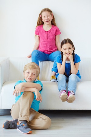 Three little friends looking at camera with smiles の写真素材
