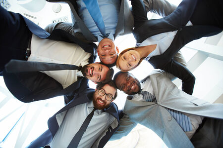 Group of friendly businesspeople in suits standing head to headの写真素材
