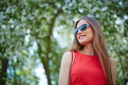 Portrait of happy girl in sunglasses outdoorsの写真素材