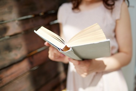 Close-up of woman reading bookの写真素材