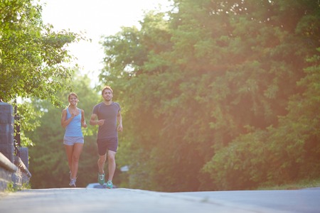 Photo of happy couple running outdoorsの写真素材