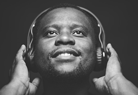 African-American guy with headphones listening to his favourite musicの写真素材