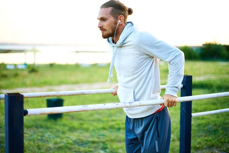 Young man training on sport equipment outside