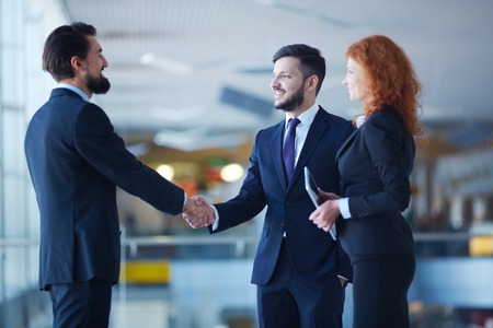 Two businessmen handshaking after striking grand dealの写真素材