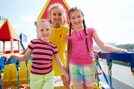 Image of cute girls spending time on playground outdoors の写真素材