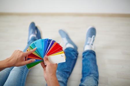 Hands of young couple during discussion of colorful paletteの写真素材
