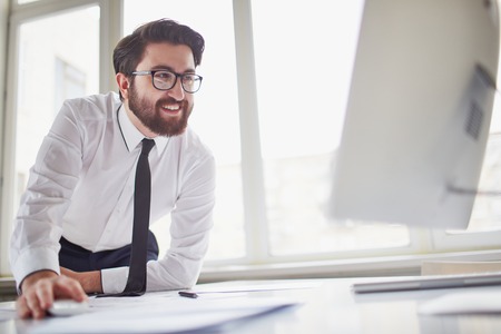 Successful businessman working with computer in office