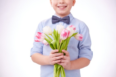 Little boy holding bunch of tulipsの写真素材