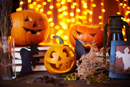 Carved pumpkins and other symbols of Halloween on sparkling 