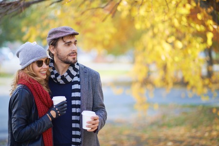 Young people walking in autumn park