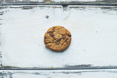One biscuit on white wooden backgroundの写真素材