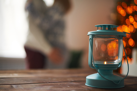 Lantern on wooden table on background of loversの写真素材
