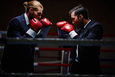 Business boxers attacking one anotherの写真素材