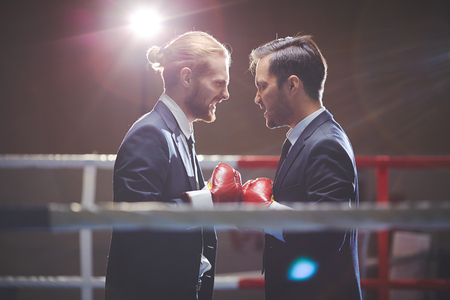 Aggressive business boxers looking at one anotherの写真素材