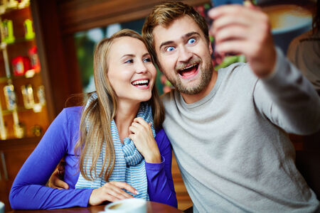 Ecstatic young couple taking their selfieの写真素材