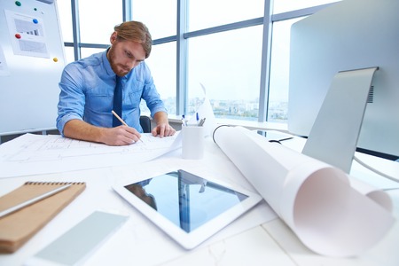 Modern architect drawing new sketch in office