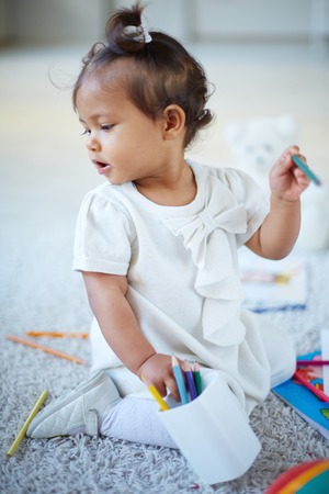 Portrait of adorable little girl with colorful pencilsの写真素材