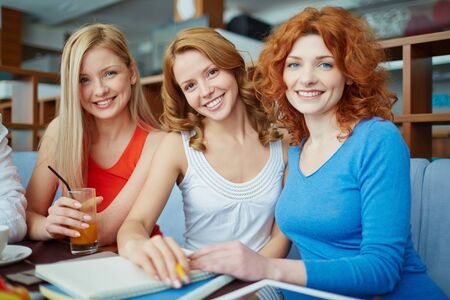 Three pretty ladies sitting at cafe