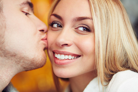 Close-up of happy woman being kissedの写真素材