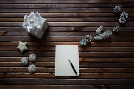 Sheet of paper on table among xmas thingsの写真素材