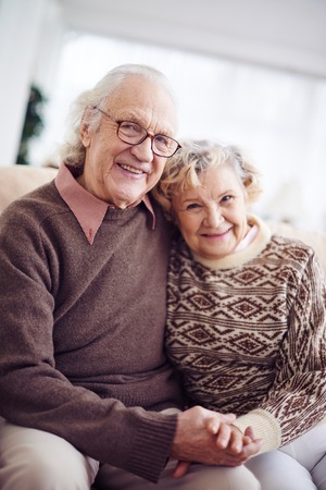 Casual pensioners looking at camera with smilesの写真素材