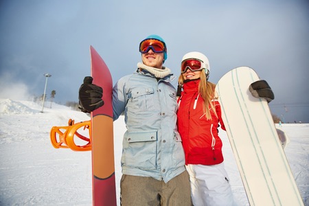 Female and male with snowboards having active leisureの写真素材