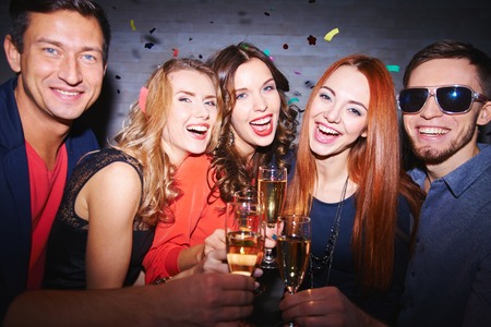 Ecstatic friends with champagne having partyの写真素材