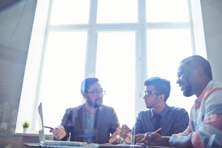 Confident manager presenting new business project to his colleagues in office