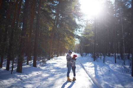 Amorous couple having romantic date in winter forestの写真素材