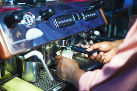 Male hands during making coffeeの写真素材