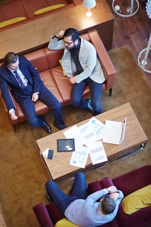 Group of male employees having meeting in officeの写真素材