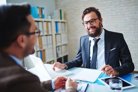 Elegant businessman talking to intervieweeの写真素材