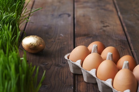 Special container with eggs and the golden one near byの写真素材
