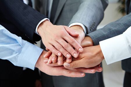 Business people hands on top of each otherの写真素材