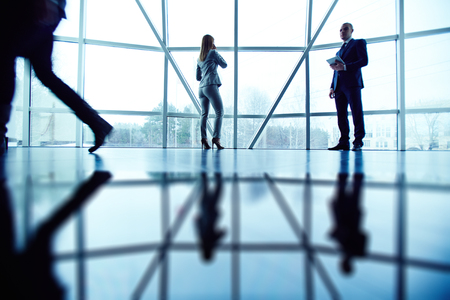 Businessman and businesswoman using modern technologies in officeの写真素材