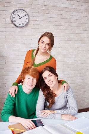 Group of students sitting in library after classesの写真素材