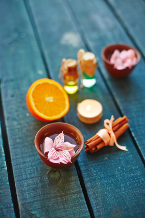 Lotus flower, orange and cinnamon on tableの写真素材
