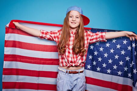 Pretty girl holding the American flagの写真素材