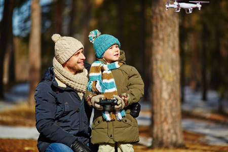 Father and son observing toy plane