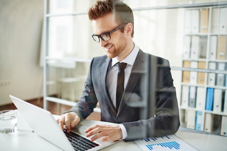 Happy businessman networking in officeの写真素材