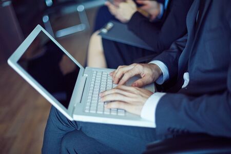 Hands of businessman during typing at conference