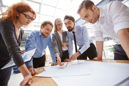 Businessman explaining project to his colleagues at meetingの写真素材