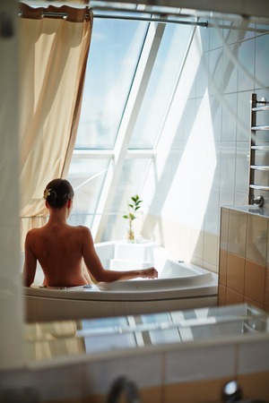 Relaxed female enjoying warm bathの写真素材