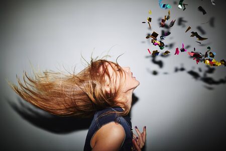 Energetic female dancer with blond hair in nightclubの写真素材