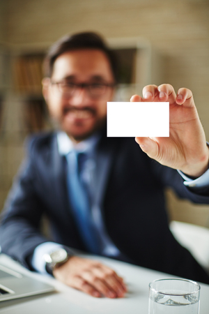 Hand of businessman with blank card introducing himself to partnerの写真素材