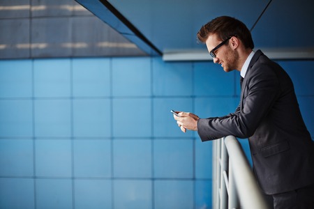 Businessman in formalwear using cellphoneの写真素材