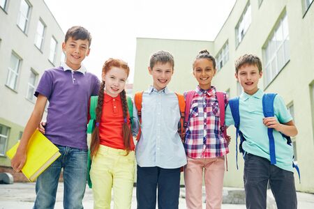 Row of successful learners looking at camera outsideの写真素材