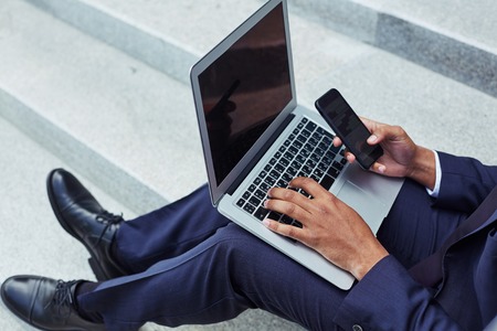 Modern businessman using electronic gadgetsの写真素材